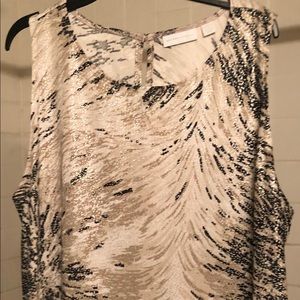 sleeveless print tunic top with asymmetrical hem.